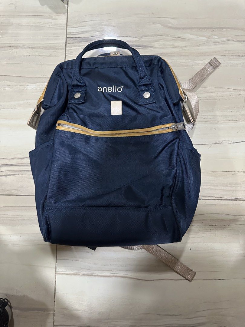 Anello Navy Blue Backpack (Category: Backpacks) located in Manila. Submitted by alyxxelijah (Listing ID 1467084733, Image 1). Description: - Storage: Spacious main compartment, front zippered pocket, and internal slip pockets. Laptop compartment (Mac air) - Condition: Sturdy and clean overall, with fraying along the top interior pocket hem.