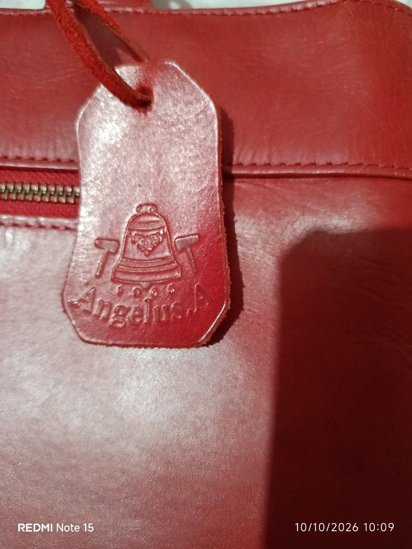 Angelus A Red Leather Tote Bag (Category: Tote Bags) located in Iloilo. Submitted by princessd99218 (Listing ID 1466983246, Image 3). Description: - Authentic vintage Angelus A leather tote bag (est. 1965) - Eye-catching bright red grain leather with clean stitching - Structured shape with comfortable dual top handles - Convenient front exterior zip pocket with matching leather pull tab - Elegant gold-tone hardware and branded hanging leather tag