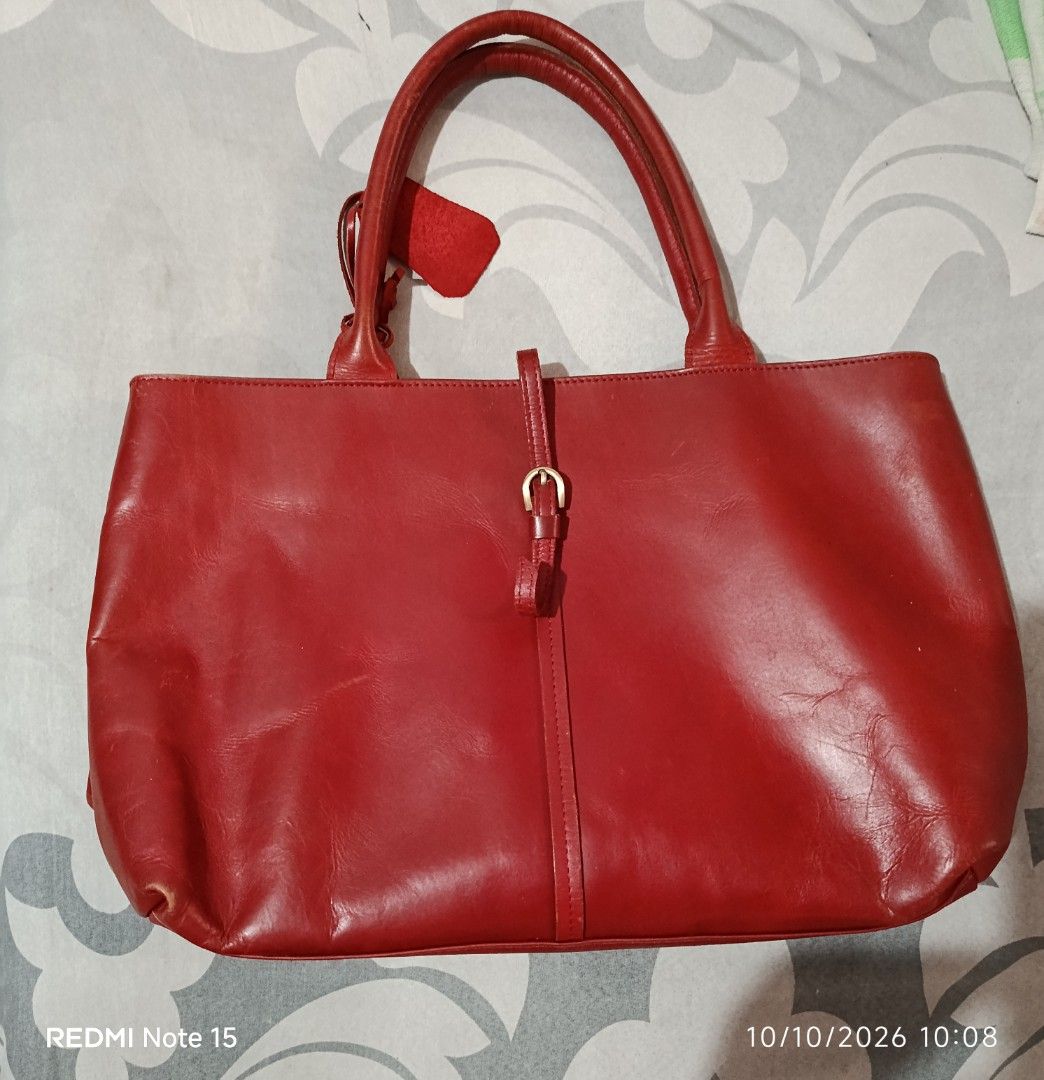 Angelus A Red Leather Tote Bag (Category: Tote Bags) located in Iloilo. Submitted by princessd99218 (Listing ID 1466983246, Image 2). Description: - Authentic vintage Angelus A leather tote bag (est. 1965) - Eye-catching bright red grain leather with clean stitching - Structured shape with comfortable dual top handles - Convenient front exterior zip pocket with matching leather pull tab - Elegant gold-tone hardware and branded hanging leather tag