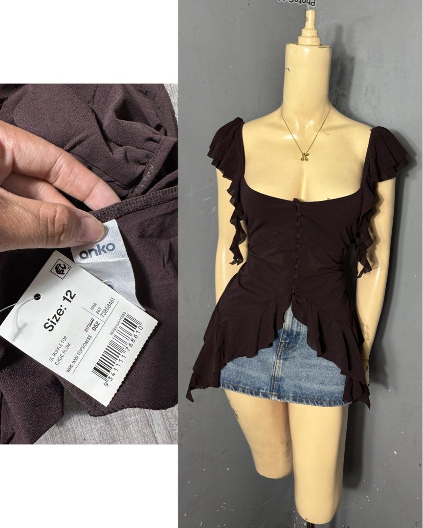 Anko Chocolate Plum Ruffle Top Size 12 (Category: Sleeveless) located in Tagum. Submitted by silentdragon_cc54e2 (Listing ID 1467030939, Image 1). Description: - Brand: Anko - Condition: Brand new with original tag attached - Size: 12 - Color: Chocolate Plum - Neckline: Square neck with decorative front buttons - Sleeves: Short cap sleeves - Hem: Ruffled trim with a unique asymmetrical cut (longer at the sides) - Fabric: Lightweight crinkle textu