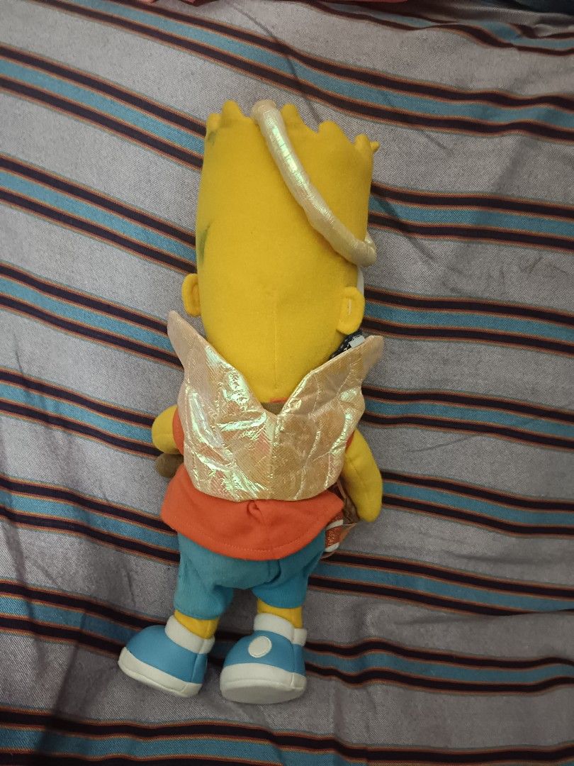 Applause 2004 Bart Simpson Cupid Angel Plush Toy (Category: Plushies & Soft Toys) located in Baguio. Submitted by adulagan1998258 (Listing ID 1467084018, Image 3). Description: - Rare 1979-2004 Applause 25th Anniversary Edition Bart Simpson Cupid plush - Features shiny golden wings, a halo, and a slingshot holding candy canes - Classic outfit: orange shirt, blue shorts, and blue sneakers - Original Applause tag attached on the wing - Great additi