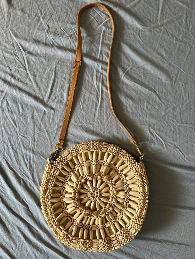 Aranaz Round Bag (Category: Beach Bags) located in Quezon City. Submitted by tan__k (Listing ID 1467068990, Image 1). Description: 12”diameter, 2”D NO Handle drop 24” optional strap drop Wooden beads mimic sun-soaked puka shells on this classic crossbody. Cotton canvas; cotton lining Wood bead embellishment Two inner slip pockets Removable strap Each design is a treasure made entirely by hand, in the Philippines Last price already.