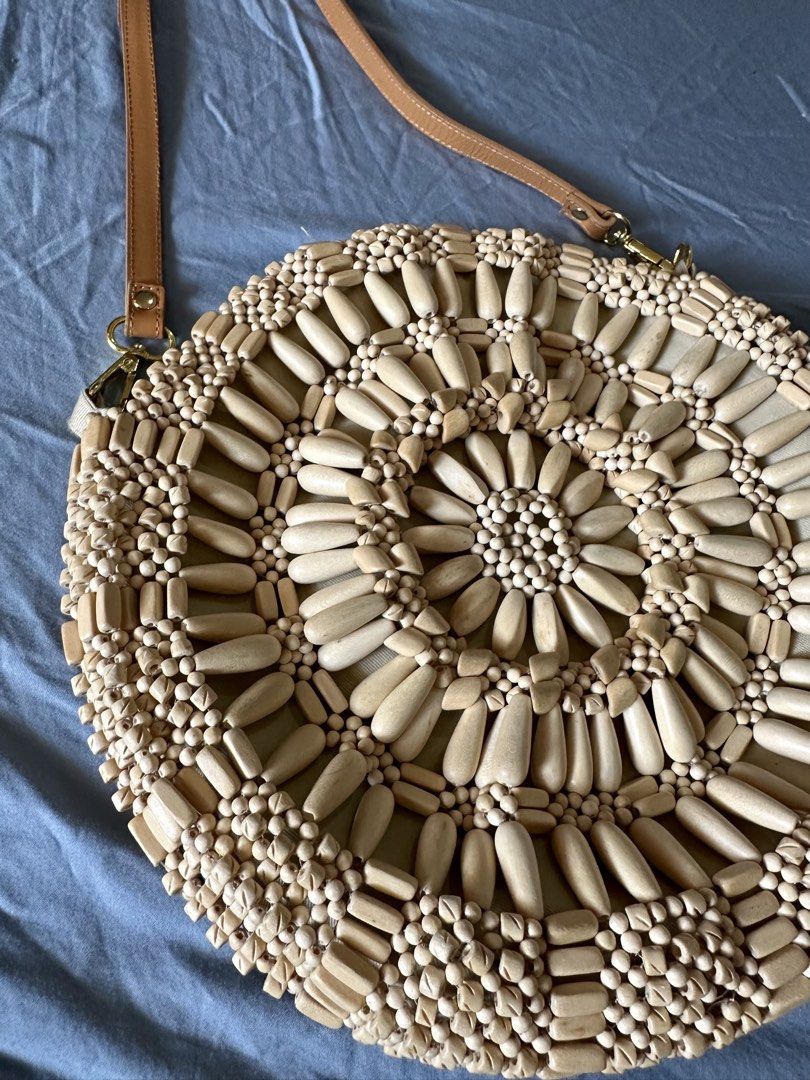Aranaz Round Bag (Category: Beach Bags) located in Quezon City. Submitted by tan__k (Listing ID 1467068990, Image 3). Description: 12”diameter, 2”D NO Handle drop 24” optional strap drop Wooden beads mimic sun-soaked puka shells on this classic crossbody. Cotton canvas; cotton lining Wood bead embellishment Two inner slip pockets Removable strap Each design is a treasure made entirely by hand, in the Philippines Last price already.
