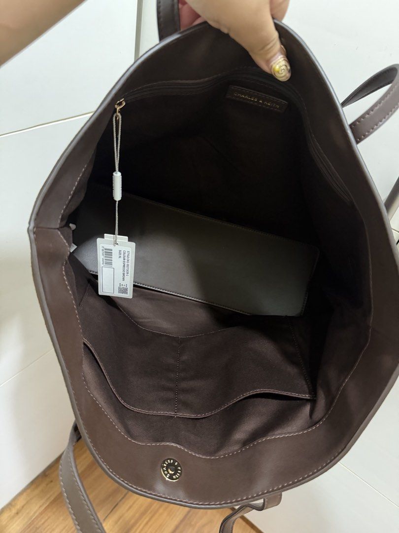 Arlet Recycled Suede Double-Handle Belted Tote Bag (Category: Tote Bags) located in Davao. Submitted by pamdyclutters (Listing ID 1467133463, Image 3). Description: - Brand: Charles & Keith - Style: Suede Tote Bag (XL) - Color: Espresso Brown with gold-tone hardware - Condition: Brand new with original tag attached - Features: Spacious interior, slip pockets, secure zipper pocket, and magnetic button closure - Design: Decorative thin front strap 