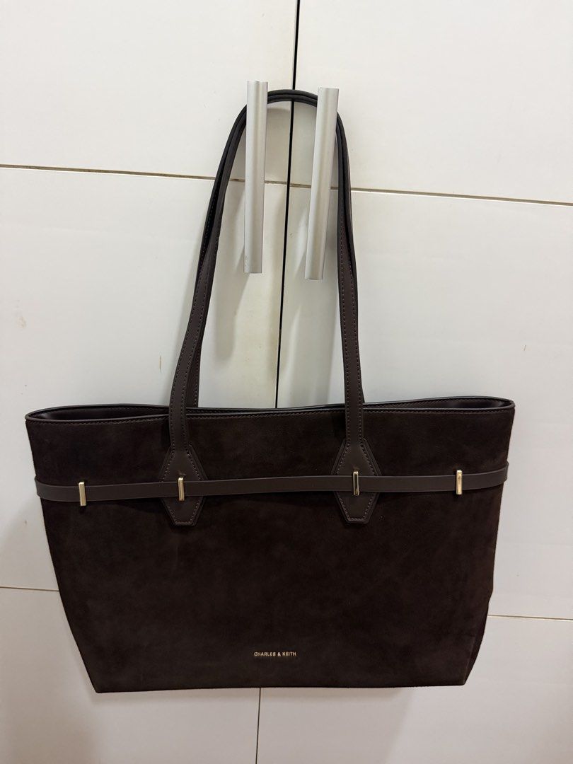 Arlet Recycled Suede Double-Handle Belted Tote Bag (Category: Tote Bags) located in Davao. Submitted by pamdyclutters (Listing ID 1467133463, Image 2). Description: - Brand: Charles & Keith - Style: Suede Tote Bag (XL) - Color: Espresso Brown with gold-tone hardware - Condition: Brand new with original tag attached - Features: Spacious interior, slip pockets, secure zipper pocket, and magnetic button closure - Design: Decorative thin front strap 