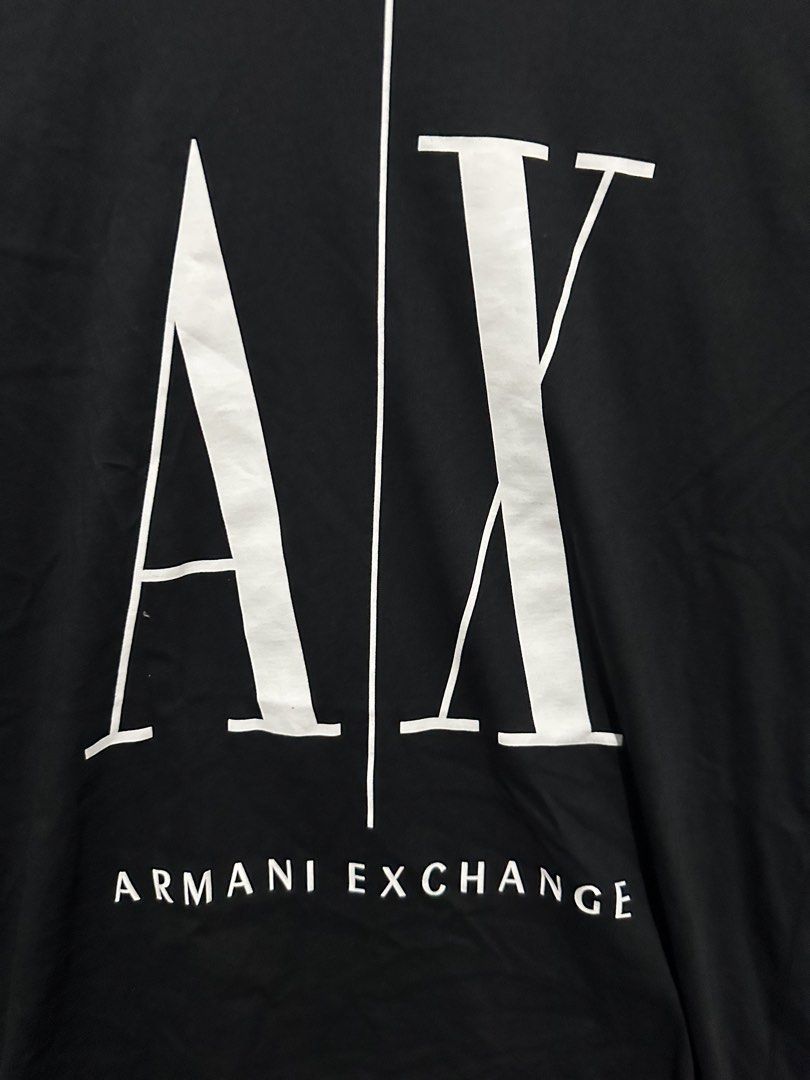 Armani Exchange Black A/X Logo Tee Size M (Category: Tshirts & Polo Shirts ) located in Villasis. Submitted by justinramosonfb (Listing ID 1467118910, Image 2). Description: - Brand: Armani Exchange - Color: Black - Size: Medium (tag at collar) - Design: Large white A/X logo with branding on the chest - Fit: Regular fit with standard crew neck - Origin: Made in Vietnam - Authenticity: Includes interior care label with QR authentication code - Con