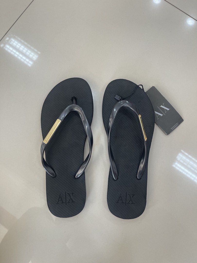 Armani Exchange Flip Flops Size 7W (Category: Slippers and slides) located in Bauang. Submitted by Fuzakenn (Listing ID 1466989217, Image 1). Description: Armani Exchange thong sandals in black. Grey translucent straps with gold-tone metal brand plate. Textured footbed with embossed A/X logo on the heel. Size 7W. Brand new with original tags attached showing twenty-five dollars retail price. ALL DETAILS POSTED NO ISSUE LA UNION J&T/JRS EXPRESS GC