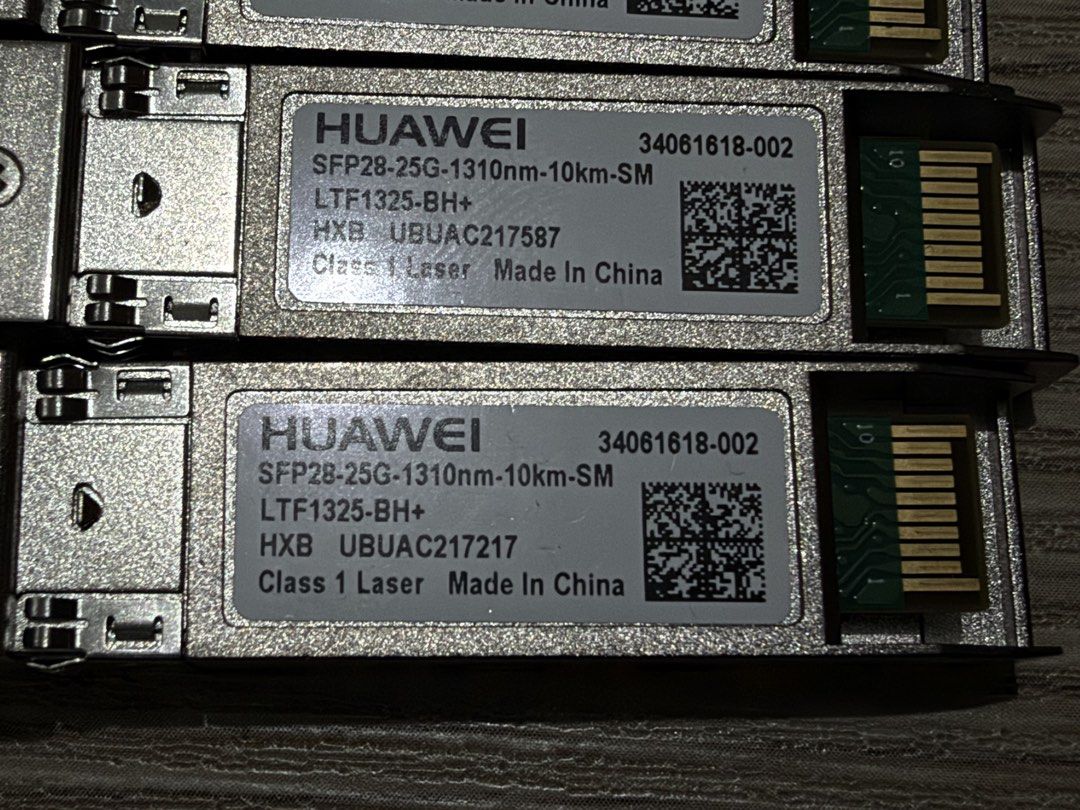 Assorted SFP, SFP+, and SFP28 Fiber Optic Transceiver Modules (Category: Computer Parts) located in Manila. Submitted by safestorm.886e55 (Listing ID 1467116089, Image 2). Description: Collection of various fiber optic transceiver modules. Includes four Huawei SFP28 25G 1310nm 10km modules, Nokoxin 10G-LRW and SFP-GE-LX-SM1310-C modules, Tang Ku Fiber SFP-GY-LX-LC-1.25G, and a generic SFP-GE-LX 1.25G 1310nm 10km module. All units clearly labeled 