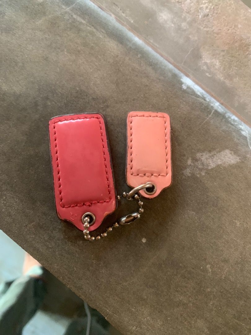 Authentic Coach Pink Leather Hangtags Bag Charm (Category: Luxury Bags & Wallets) located in Piddig. Submitted by yhanshop (Listing ID 1467040855, Image 2). Description: - 100% genuine Coach leather hangtags - Colors: Hot pink and light pink - Includes attached metal ball chains - Features embossed Coach logo and stitched borders - Ideal replacement for missing bag charms or decorative keychains.