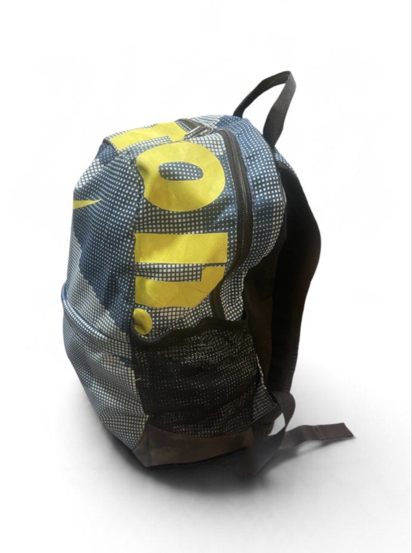 Authentic Nike Brasilia 20L Casual Backpack Unisex (Category: Backpacks) located in San Pedro. Submitted by lifebeginsaftercoff33 (Listing ID 1467078778, Image 3). Description: - Eye-catching blue and white grid pattern with bright yellow Nike Swoosh and 'JUST DO IT' branding - Practical side mesh pockets for water bottles or umbrellas - Comfortable padded black back panel ideal for all-day wear - Convenient top grab handle for easy carrying - Us