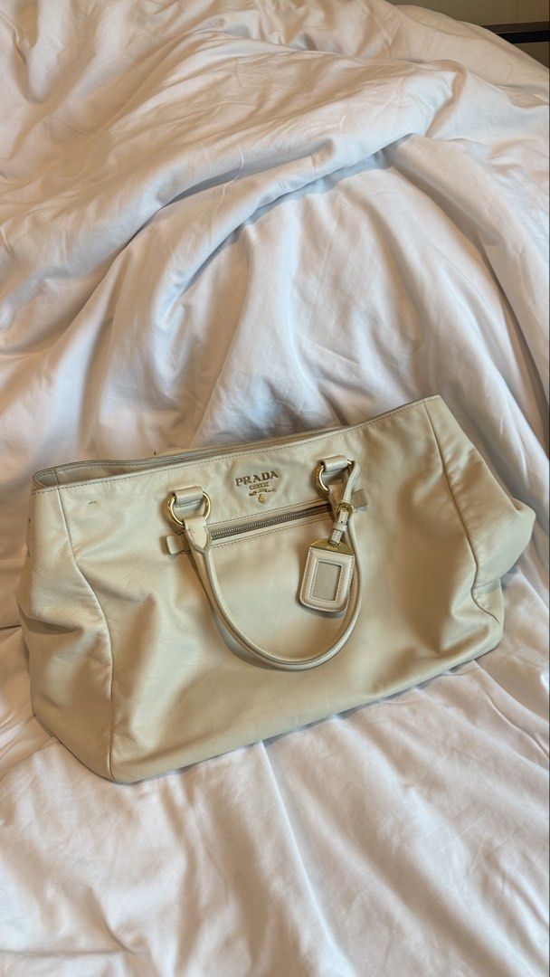 Authentic Prada White Two-Way Sling Crossbody Bag (Category: Luxury Bags & Wallets) located in Taguig. Submitted by maliashoppingaccount (Listing ID 1467015446, Image 1). Description: Authentic Prada Two-Way Bag White Excellent condition 💯 Money back guarantee Add 2k for legitgrails certificate Only flaw on the handle as seen on photo Not obvious because it’s underneath .