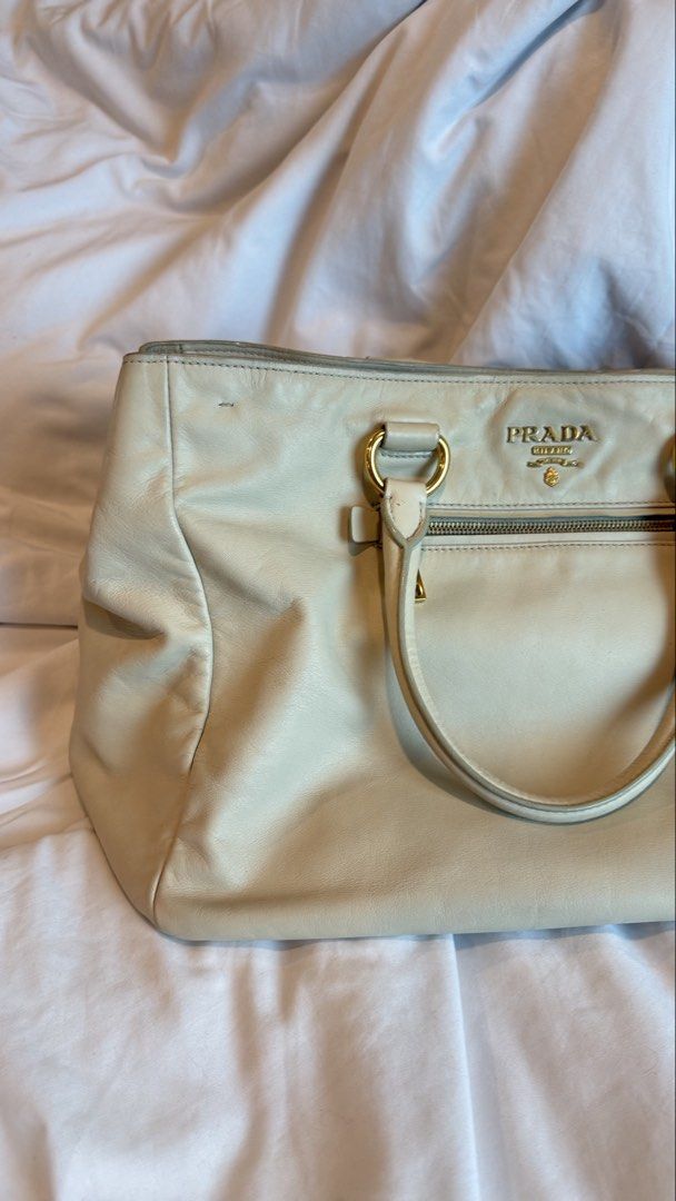 Authentic Prada White Two-Way Sling Crossbody Bag (Category: Luxury Bags & Wallets) located in Taguig. Submitted by maliashoppingaccount (Listing ID 1467015446, Image 2). Description: Authentic Prada Two-Way Bag White Excellent condition 💯 Money back guarantee Add 2k for legitgrails certificate Only flaw on the handle as seen on photo Not obvious because it’s underneath .