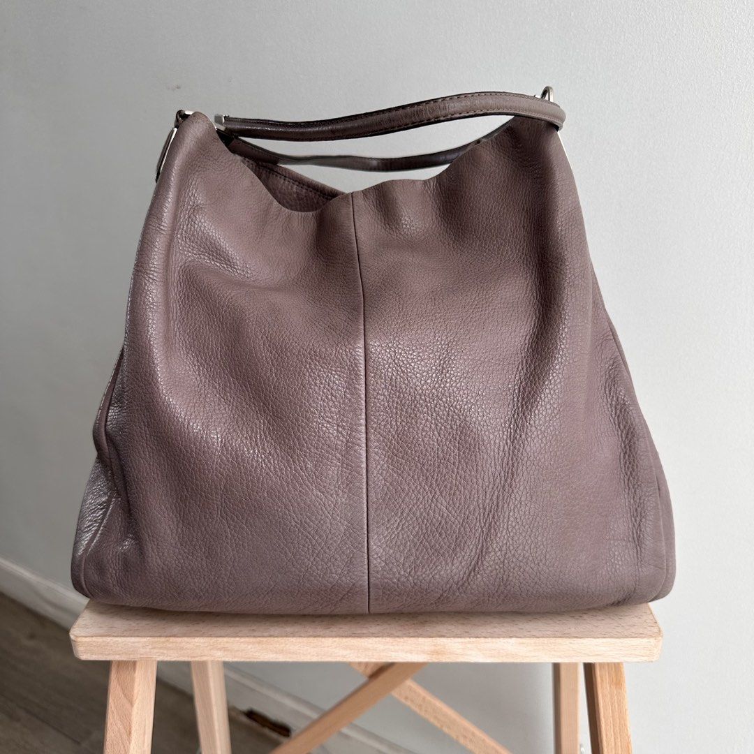 Authentic Vintage Coach Leather Hobo Bag (Category: Luxury Bags & Wallets) located in Paranaque City. Submitted by closetmalou (Listing ID 1467116257, Image 1). Description: Authentic Vintage Coach Leather Hobo Bag Beautiful Coach shoulder bag in a unique taupe-mauve shade, featuring soft pebbled leather, silver-tone hardware, a spacious interior, and a zippered front pocket. A timeless everyday bag with a relaxed, slouchy silhouette. Size: * Bot