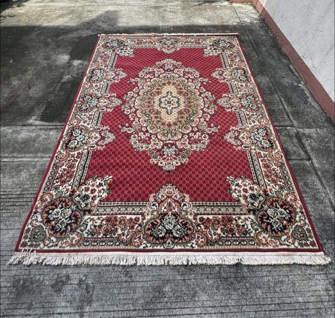Available- Red Persian Style (Category: Carpets, Mats & Flooring) located in Manila. Submitted by swiftearth-726f (Listing ID 1467062033, Image 1). Description: - Design: Traditional Persian-inspired pattern with intricate floral details - Color Palette: Deep red background with beige, black, and green accents - Features: Beautiful decorative fringe along both ends - Texture: Thick pile, very soft and comfortable underfoot - Condition: Clean over