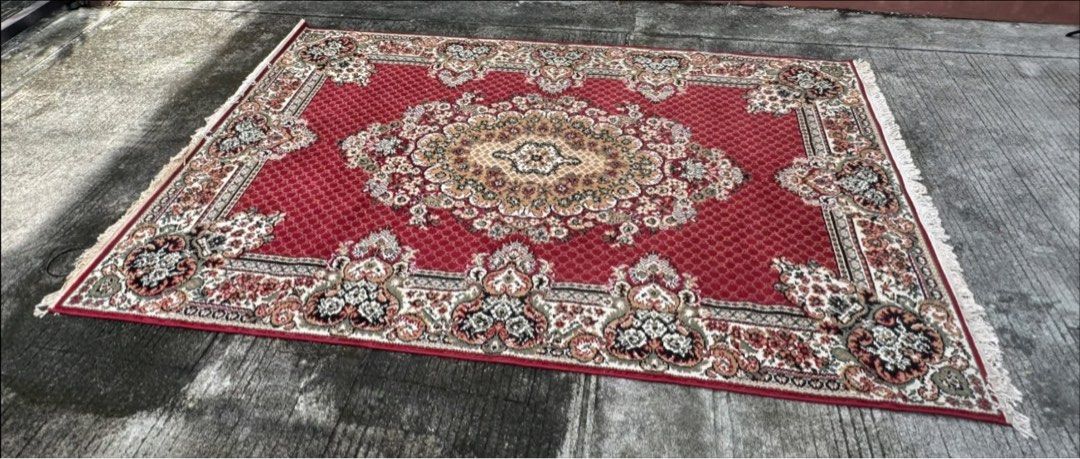 Available- Red Persian Style (Category: Carpets, Mats & Flooring) located in Manila. Submitted by swiftearth-726f (Listing ID 1467062033, Image 2). Description: - Design: Traditional Persian-inspired pattern with intricate floral details - Color Palette: Deep red background with beige, black, and green accents - Features: Beautiful decorative fringe along both ends - Texture: Thick pile, very soft and comfortable underfoot - Condition: Clean over