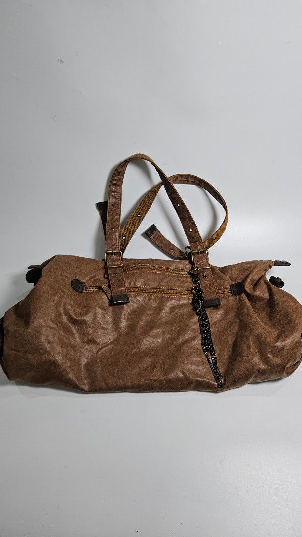 AVIREX Brown duffel Bag (Category: Shoulder Bags) located in Alfonso. Submitted by jbcamet (Listing ID 1467074363, Image 3). Description: - Brand: AVIREX - Material: Brown faux leather with clean beige fabric lining - Straps: Double shoulder straps with adjustable buckles - Closure: Secure top zipper closure - Storage: Spacious interior with an included base support insert - Extras: Removable black chain accessory on the front zip pocket - Condit