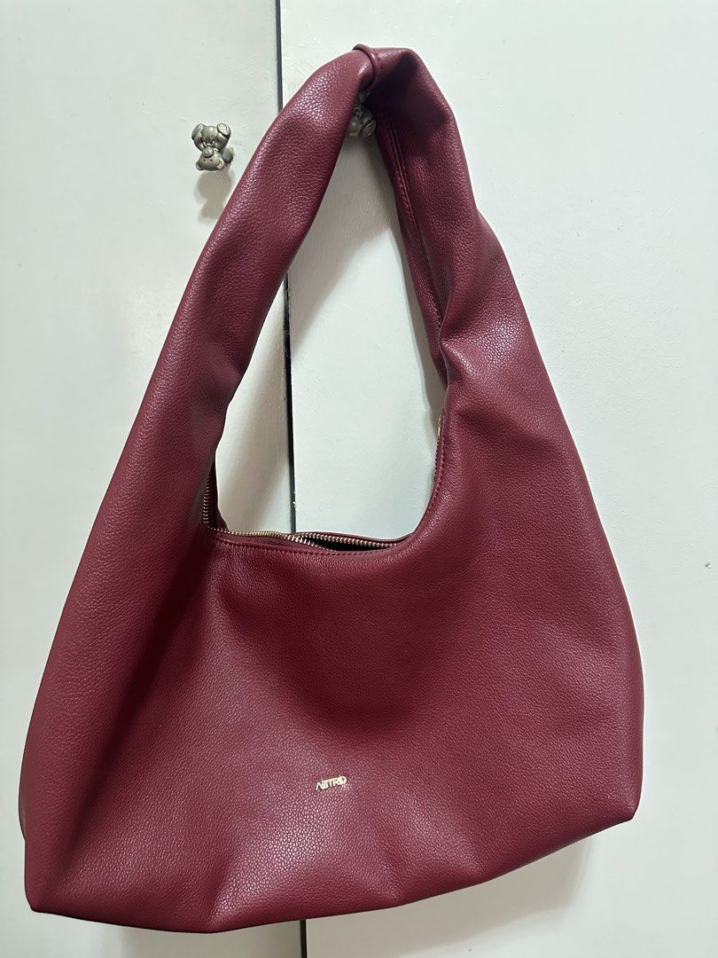 AZTRID Medium Hobo Bag (Category: Shoulder Bags) located in Muntinlupa City. Submitted by faythemagsombol23 (Listing ID 1466980688, Image 1). Description: - Brand: Aztrid - Color: Deep Burgundy - Style: Slouchy hobo shoulder bag with a thick, comfortable strap - Gold zipper and small gold logo stamp on the front - Condition: Clean inside and out, roomy enough for daily essentials - Lighty used.