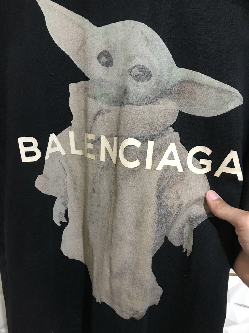 Balenciaga Grogu Star Wars Graphic Tee Black (Category: Luxury Apparel) located in Rizal. Submitted by drthriftone (Listing ID 1466973253, Image 2). Description: - Brand: Balenciaga - Design: Grogu graphic with white logo lettering on front - Fit: Relaxed fit with classic crew neckline - Color: Black - Origin: Made in Portugal - Measurements: As shown on tag taped to collar - Condition: 100% authentic, well-maintained.