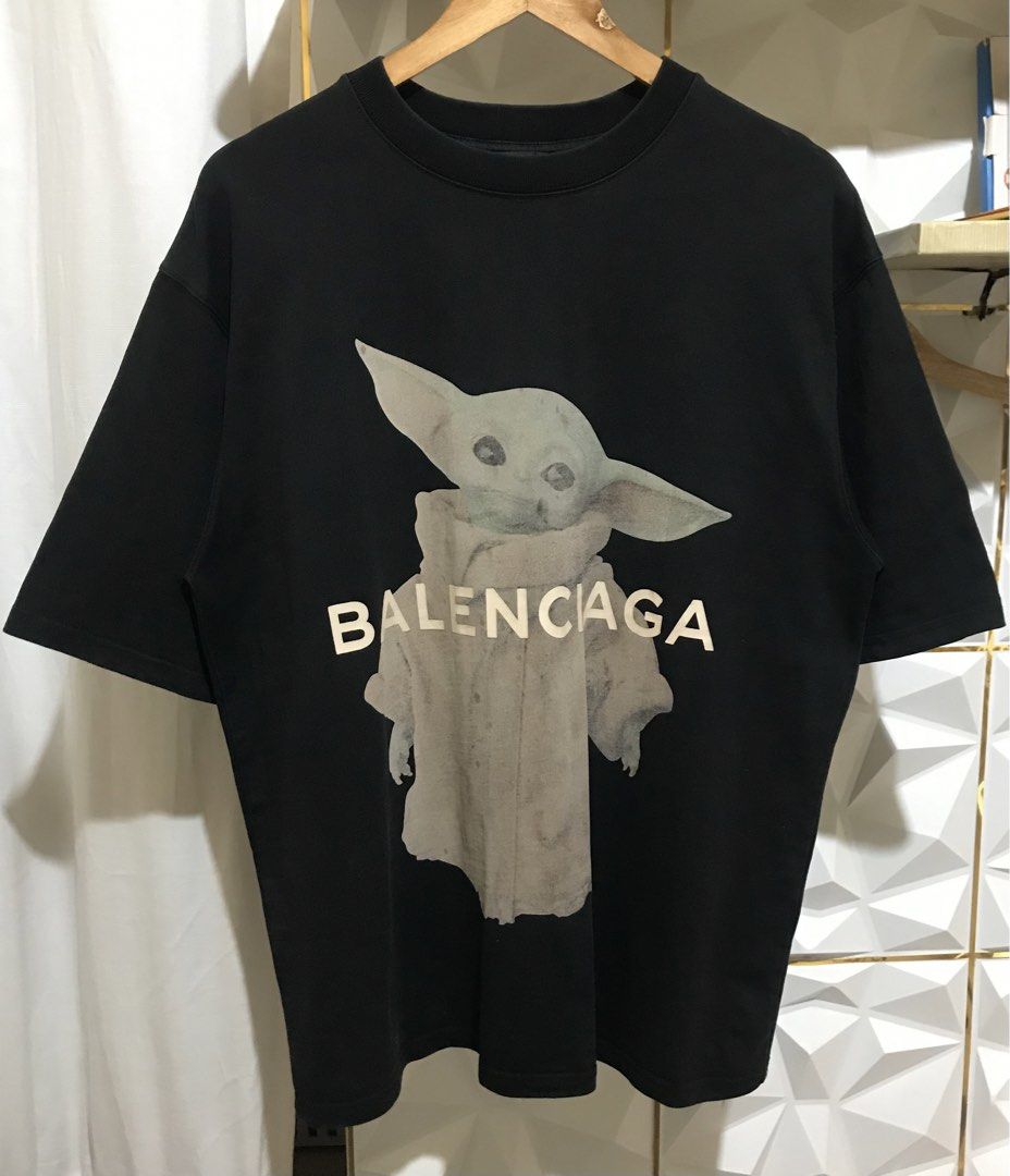 Balenciaga Grogu Star Wars Graphic Tee Black (Category: Luxury Apparel) located in Rizal. Submitted by drthriftone (Listing ID 1466973253, Image 1). Description: - Brand: Balenciaga - Design: Grogu graphic with white logo lettering on front - Fit: Relaxed fit with classic crew neckline - Color: Black - Origin: Made in Portugal - Measurements: As shown on tag taped to collar - Condition: 100% authentic, well-maintained.