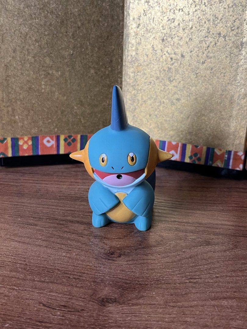 Bandai 2004 Pokémon Marshtomp Figure Nintendo (Category: Figurines & Statues) located in Gapan. Submitted by lunashop14 (Listing ID 1467164409, Image 1). Description: Authentic 2004 Bandai Marshtomp vinyl figure. Official Pokémon merchandise from Japan, featuring classic blue and yellow details. Stands on its own, showing minor paint wear due to age. A great vintage addition to any Pokémon collection!.