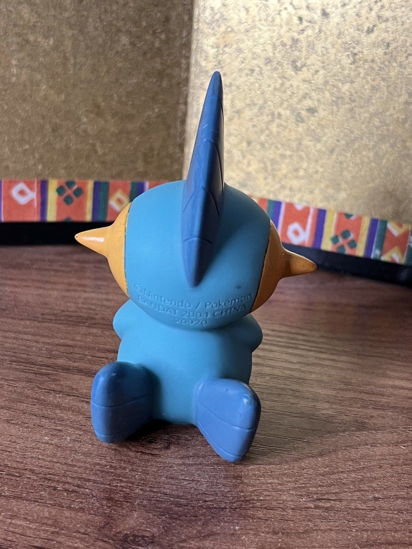 Bandai 2004 Pokémon Marshtomp Figure Nintendo (Category: Figurines & Statues) located in Gapan. Submitted by lunashop14 (Listing ID 1467164409, Image 2). Description: Authentic 2004 Bandai Marshtomp vinyl figure. Official Pokémon merchandise from Japan, featuring classic blue and yellow details. Stands on its own, showing minor paint wear due to age. A great vintage addition to any Pokémon collection!.