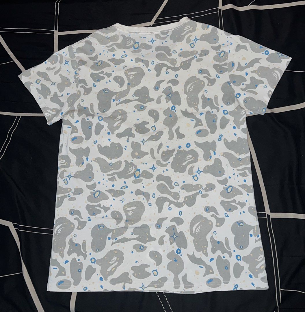 BAPE A Bathing Ape Space Camo Shirt (Category: Tshirts & Polo Shirts ) located in Cebu City. Submitted by jlturno1999 (Listing ID 1467127801, Image 2). Description: BAPE A Bathing Ape Space Camo Shirt Good for PSG 21x28 dimensions 9/10 color rate Issue hairline, blue and black stain, bacon neck Need wash.
