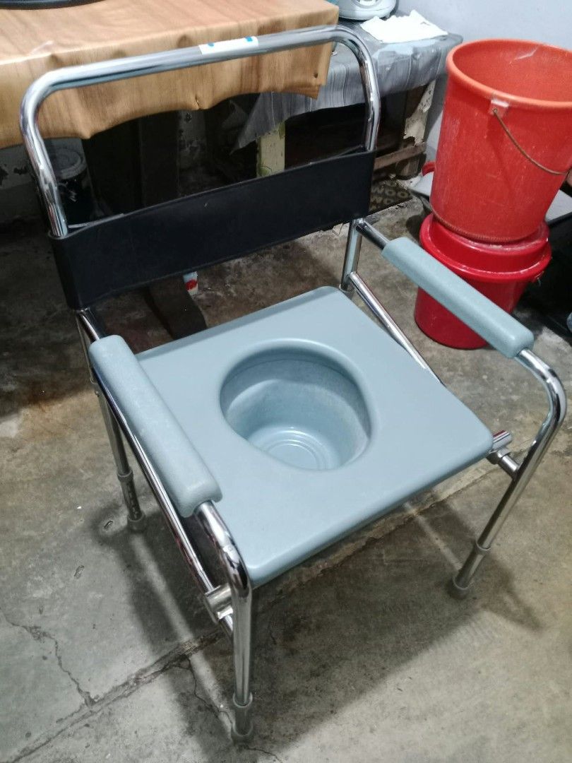 Bedside Commode Chair with Padded Seat and Armrests (Category: Medical Supplies & Tools) located in Manila. Submitted by bunshoy09 (Listing ID 1467108201, Image 2). Description: - Adjustable height bedside commode chair - Sturdy chrome frame with anti-slip rubber tips - Comfortable padded seat cover that lifts to reveal commode bucket - Padded armrests and back strap for extra support - Ideal mobility aid for elderly or disabled users at home bne