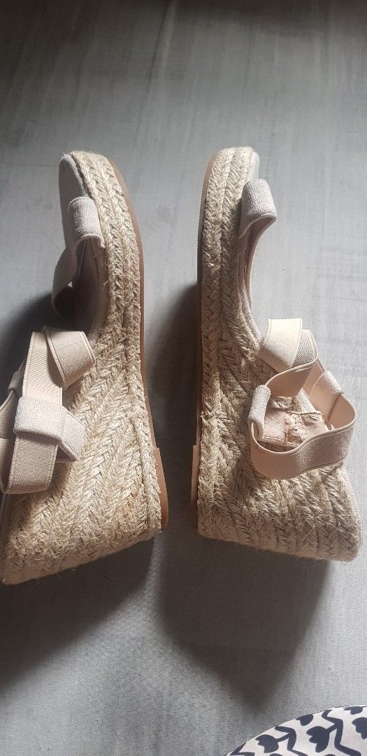 Beige Elastic Straps Wedge Sandals Espadrilles (Category: Flats & Sandals) located in Quezon City. Submitted by seventeenjeonghan (Listing ID 1467002898, Image 3). Description: - Color: Nude beige (matches any outfit) - Heel: Espadrille jute-wrapped wedge - Fit: Comfortable stretch elastic cross straps - Design: Open toe with soft fabric footbed - Style: Easy slip-on, perfect for warm weather.