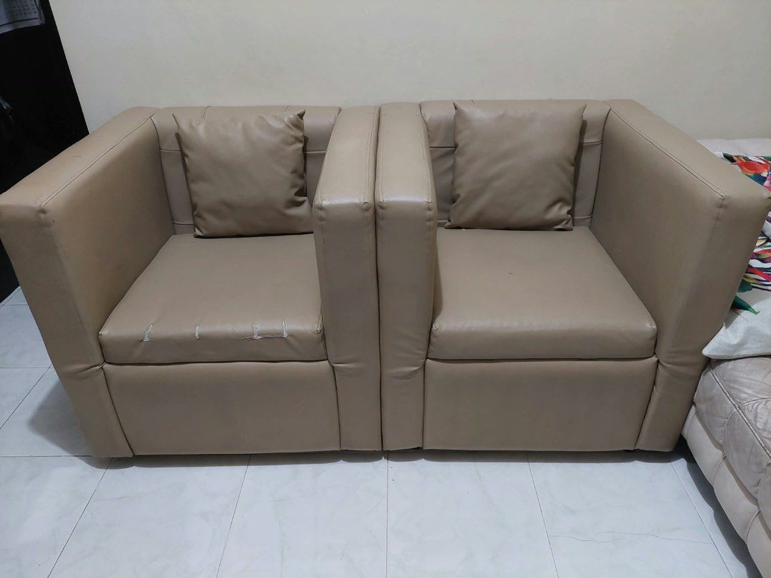 Beige Faux Leather Storage Sofa 2-Seater (Category: Sofas) located in Manila. Submitted by lu.ci (Listing ID 1466974423, Image 1). Description: 33x30x32 Nasa pictures po ang flaws - Beige faux leather 2-seater sofa with matching throw pillows - Dual hidden storage compartments under both flip-up seats - Compact size, perfect for small living spaces or bedrooms - Clean neutral color that complements any room decor - Sturdy and durable frame overal