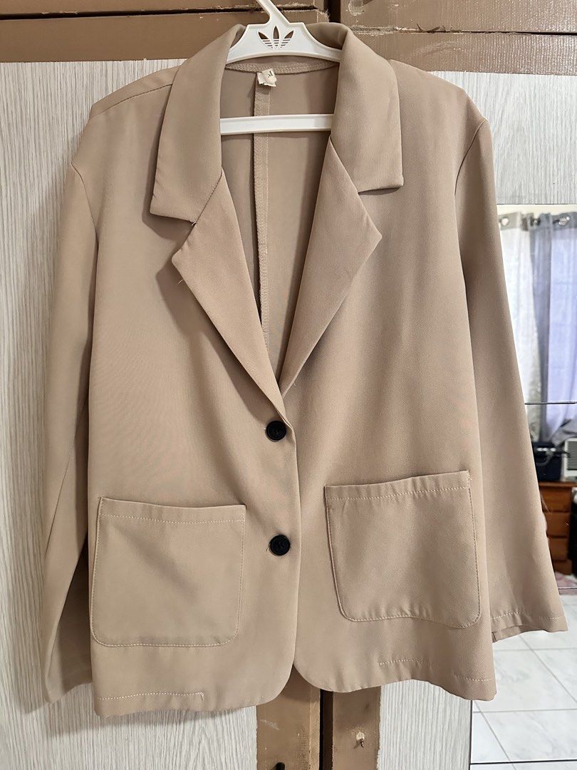 Beige oversized blazer with front pockets size M (Category: Coats, Jackets and Outerwear) located in Paranaque City. Submitted by moonbea (Listing ID 1467038538, Image 1). Description: - Color: Classic beige - Size: M (tag visible at collar) - Fit: Relaxed fit with structured lapels - Pockets: Two front patch pockets - Closure: Two black buttons - Back: Plain design with center seam - Material: Smooth, easy-to-pair fabric ideal for casual or smar