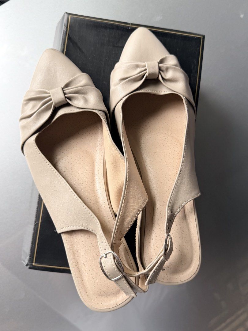 Beige Pointed-Toe Slingback Heels with Bow Detail (Category: Heels) located in Caloocan City. Submitted by ashpreloves (Listing ID 1467086095, Image 2). Description: - Style: Beige pointed-toe slingback heels with a sweet front bow - Heel: Comfortable low block heel for easy walking - Fit: Adjustable ankle strap with silver buckle - Material: Smooth faux leather with a cushioned inner sole - Condition: Clean overall, minimal signs of wear - Inclu