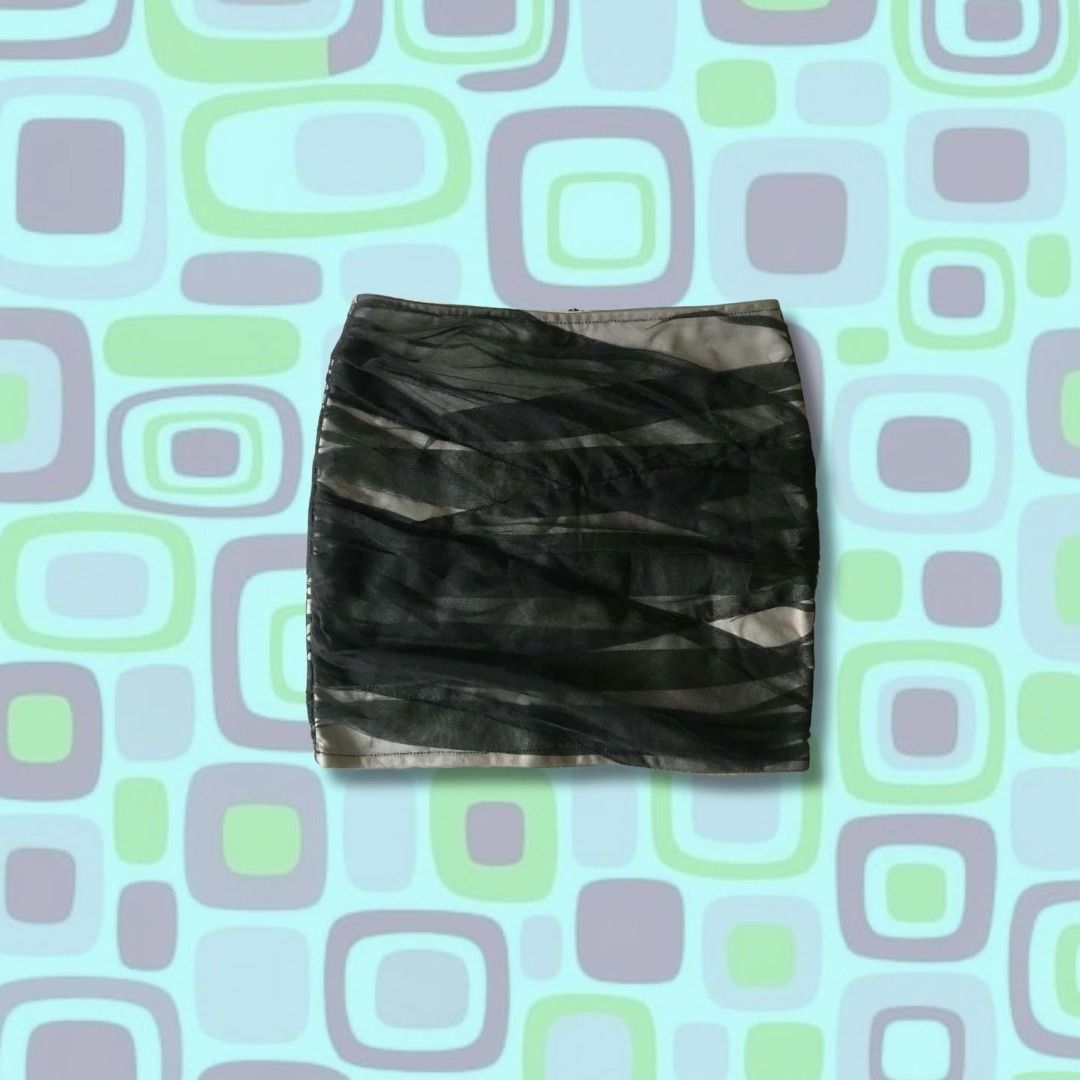 Black and Beige Mesh Layered Mini Skirt (Category: Skirts) located in Pili. Submitted by xi4cl0set (Listing ID 1467008184, Image 3). Description: - Color & Pattern: Black mesh overlay on beige base creating a chic striped effect - Length: Short mini length - Details: Trendy exposed zipper down the back - Fit: Stretchy fabric that hugs curves nicely - Best For: Nights out, clubbing, or pairing with basic crop tops - Condition: From a smoke-free ho