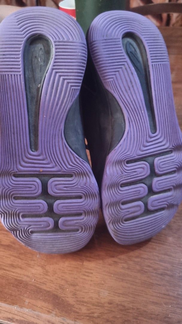 Black and Purple Athletic Sneakers (Category: Babies & Kids Fashion) located in Calamba. Submitted by kortking18 (Listing ID 1466977733, Image 3). Description: - Color: Black with vibrant purple accents on the outsoles and insoles - Design: Mid-top style with lace-up closure and convenient heel pull tabs - Performance: Textured midsoles for enhanced grip and stability - Authenticity: Inner tags with readable style codes included - Versatility: Id