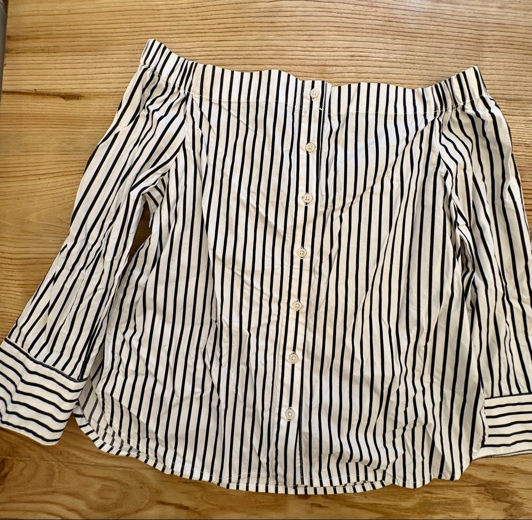 Black and white striped off-shoulder button-down blouse (Category: Blouses) located in Paranaque City. Submitted by yanionlineshopping (Listing ID 1467025732, Image 1). Description: - Trendy black and white vertical stripe pattern - Stylish off-shoulder neckline with long sleeves and button cuffs - Full front button-down placket - Flattering curved hemline that sits below the hips - Lightweight, comfortable fabric ideal for pairing with jeans or 