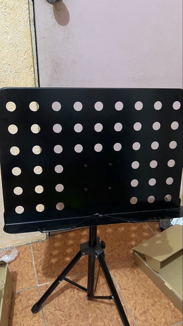Black Folding Sheet Music Stand with Carrying Case (Category: Musical Instruments) located in Manila. Submitted by silentbird.811e41 (Listing ID 1467149084, Image 1). Description: - Color: Sleek black metal - Design: Ventilated desk panel for better airflow and lighter weight - Adjustability: Fully adjustable height and angle to suit your playing style - Portability: Sturdy tripod base folds down compactly - Inclusion: Comes with a free black zip