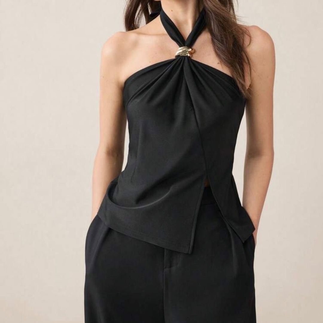Black Halter Top with Gold Ring Detail (Category: Sleeveless) located in Caloocan City. Submitted by zaramndz (Listing ID 1467124942, Image 1). Description: Sleek black halter top. Smooth fabric with nice drape. Features a chic gold metal ring right at the neckline holding the straps together. Asymmetrical split hem at the front. Pairs well with trousers or a skirt for a night out. Easy to dress up or down..