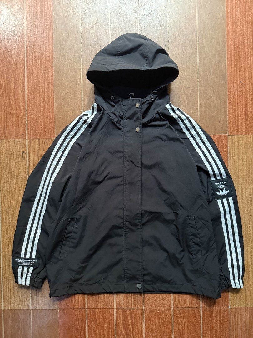 Black Hooded Jacket With Three Stripes (Category: Coats, Jackets and Outerwear) located in Dasmarinas. Submitted by kylebecker (Listing ID 1467000933, Image 1). Description: - Color: Black with white stripes down the sleeves - Closure: Snap button front - Features: Hooded, side pockets, elastic cuffs and hem - Details: Distinctive patch labels near the bottom hem and sleeve - Material: Lightweight, perfect for layering.