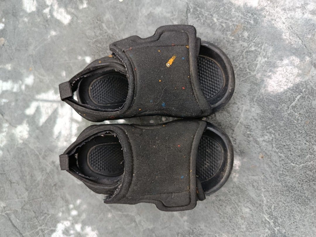 Black Kids Sandals with Space Print (Category: Babies & Kids Fashion) located in Bacolod City. Submitted by bhebisexy08 (Listing ID 1467007932, Image 2). Description: - Kids black sandals with a cute space print (comets and stars) - Convenient velcro strap closure for quick on and off - Textured footbed for added grip - Durable rubber soles - Condition: Worn with visible signs of regular usage - Perfect as a budget-friendly spare pair for playgro