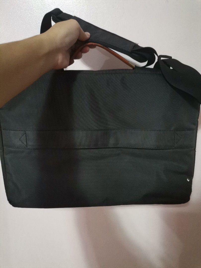 Black Laptop Bag Briefcase with Shoulder Strap (Category: Laptop Bags & Sleeves) located in Makati City. Submitted by kookybearsstuff (Listing ID 1467070206, Image 2). Description: - Color: Sleek black with stylish brown trim - Storage: Spacious main compartment for your laptop and accessories, plus two convenient front zipper pockets - Protection: Soft plush interior lining to keep your device safe from scratches - Versatility: Includes top hand