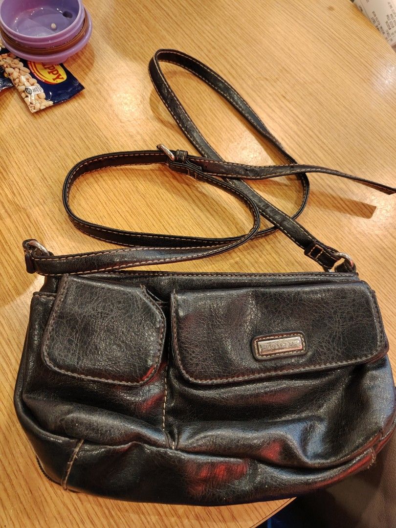 Black Leather Crossbody Bag with Multiple Compartments (Category: Cross-body Bags) located in Manila. Submitted by purediamond888 (Listing ID 1467047017, Image 2). Description: Black textured crossbody bag with adjustable strap. Two main zippered compartments up top. Front features two flap pockets with snap closures. Inside has dark lining, card slots, and an extra zip pocket. Hardware is silver tone. Compact size, good for everyday use..