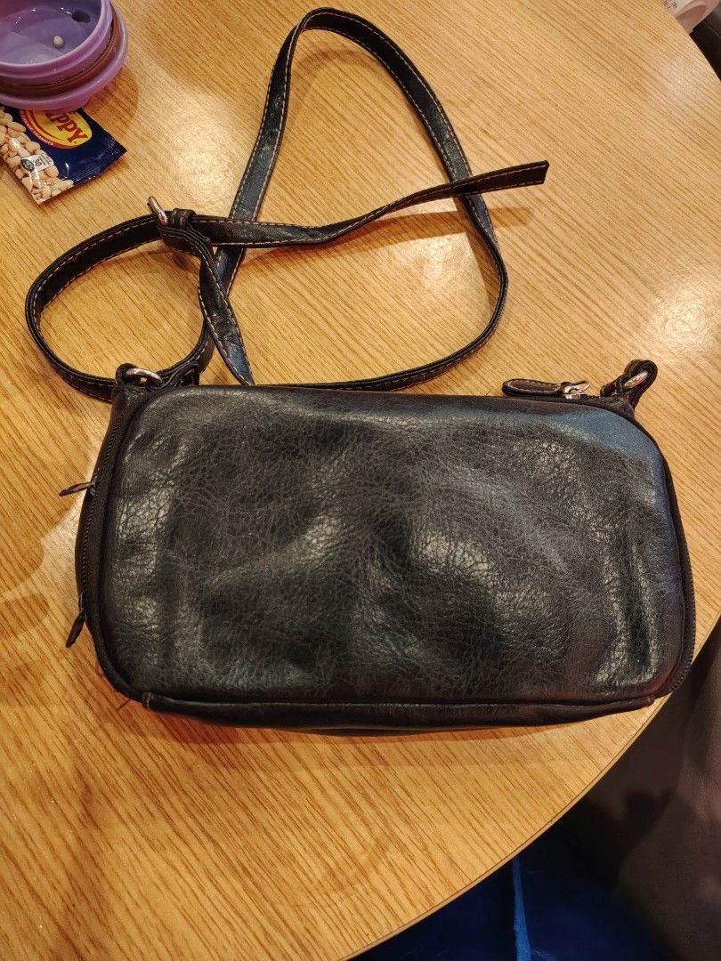 Black Leather Crossbody Bag with Multiple Compartments (Category: Cross-body Bags) located in Manila. Submitted by purediamond888 (Listing ID 1467047017, Image 3). Description: Black textured crossbody bag with adjustable strap. Two main zippered compartments up top. Front features two flap pockets with snap closures. Inside has dark lining, card slots, and an extra zip pocket. Hardware is silver tone. Compact size, good for everyday use..