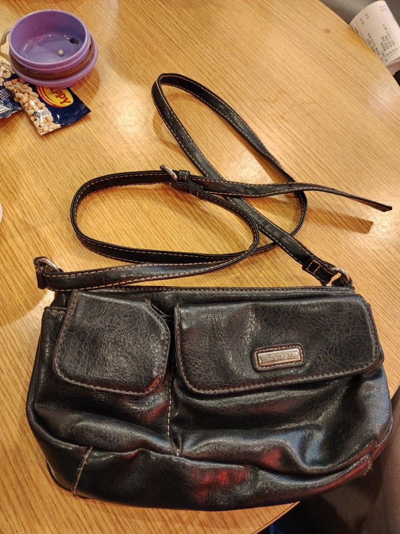 Black Leather Crossbody Bag with Multiple Compartments (Category: Cross-body Bags) located in Manila. Submitted by purediamond888 (Listing ID 1467047017, Image 1). Description: Black textured crossbody bag with adjustable strap. Two main zippered compartments up top. Front features two flap pockets with snap closures. Inside has dark lining, card slots, and an extra zip pocket. Hardware is silver tone. Compact size, good for everyday use..