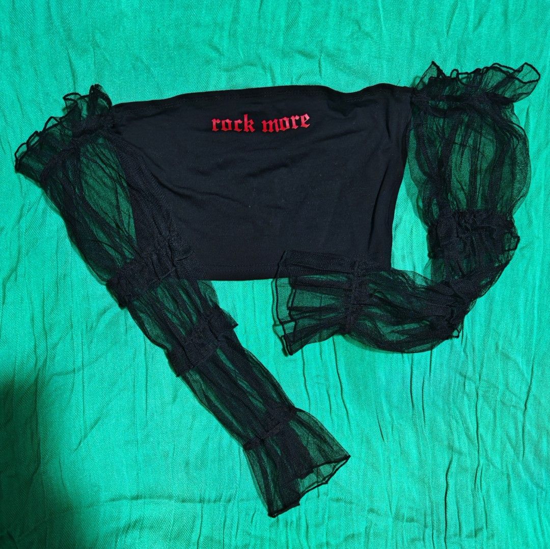 Black Mesh Long Sleeve Off Shoulder Crop Top (Category: Longsleeves) located in Paranaque City. Submitted by MLandCobyApple (Listing ID 1467031878, Image 1). Description: - Color: Black with red 'rock more' lettering - Style: Off-shoulder crop top with sheer mesh long sleeves - Details: Ruffled accents along the arms and cuffs - Fabric: Lightweight and comfortable - Condition: Good, worn a few times Buy one Get one.