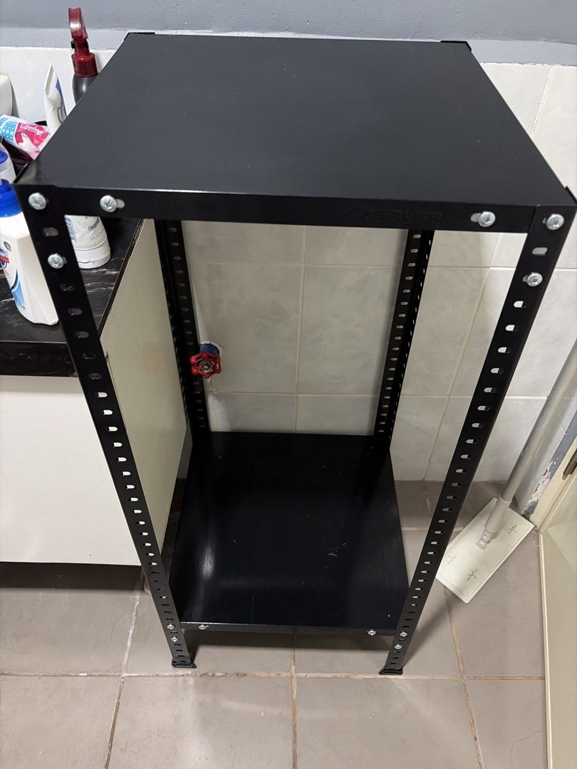 Black Metal Storage Rack Utility Shelf (Category: Shelves, Cabinets & Racks) located in Paranaque City. Submitted by EuniceG (Listing ID 1467034083, Image 1). Description: - Color/Finish: Matte black paint - Material: Sturdy steel construction - Shelves: 3 solid shelves. There’s also another shelf not installed. - Features: Adjustable upright slots on all four legs for customizable shelf height - Ideal For: Organizing tools, kitchen items, or box