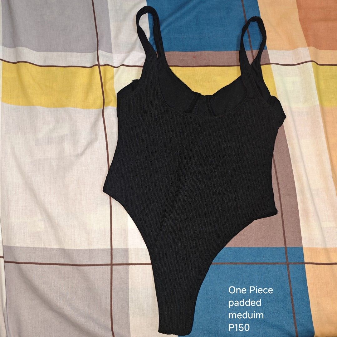 Black One Piece Padded Swimsuit Medium (Category: Bikinis & Swimsuits) located in Manila. Submitted by emailmeonj79332 (Listing ID 1467155163, Image 1). Description: - Color: Black - Size: Medium - Material: Stylish ribbed texture - Support: Built-in padding included - Design: Scoop neckline with dual straps and high-cut legs - Condition: Brand new / Great basic piece for beach and pool trips.