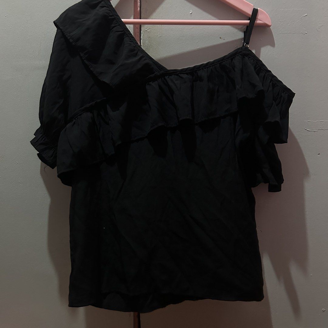 Black One-Shoulder Ruffle Blouse (Category: Blouses) located in Mandaluyong City. Submitted by strawbyeries (Listing ID 1467144565, Image 1). Description: Black one-shoulder top with statement ruffles running across the front and sleeves. Lightweight fabric, easy to pair with jeans or a skirt for a night out. Single adjustable strap on one side, half sleeve on the other. No stains or tears..