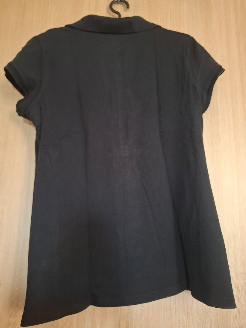Black polo shirt (Category: Shirts) located in Rizal. Submitted by mirisica (Listing ID 1467136536, Image 2). Description: - Color: Solid black - Size: Juniors XL (15/17) - Style: Short sleeve, button placket, collar - Material: 96% cotton, 4% spandex blend for extra comfort - Origin: Made in Macau - Condition: Clean, well-maintained piece.