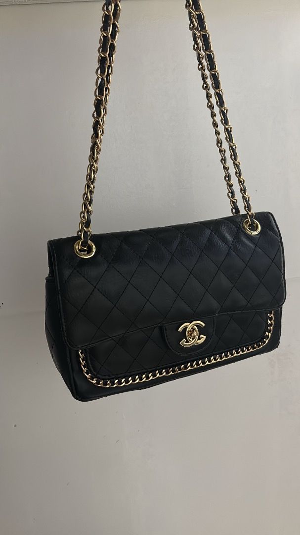 Black Quilted Shoulder Bag with Gold Chain (Category: Luxury Bags & Wallets) located in Caloocan City. Submitted by gloriannecoach.1234 (Listing ID 1467103454, Image 2). Description: - Color: Black - Material: Quilted leather - Hardware: Gold-tone - Closure: Classic turn-lock front flap - Details: Interwoven chain strap and chic chain trim along the front edge - Capacity: Roomy enough for daily essentials - Condition: Excellent/Brand New (as appl