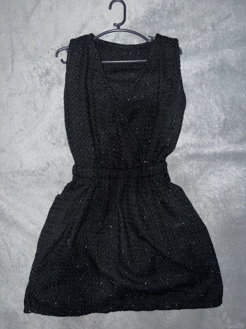 Black sparkly sleeveless mini dress (Category: Dresses) located in Cainta. Submitted by dyclutterxoxo (Listing ID 1467165480, Image 1). Description: - Color: Black with subtle shimmer thread - Style: Sleeveless, crossover V-neck, pullover design - Fit: Fitted elastic waist with a flared skirt - Fabric: Textured, slight knit feel - Occasion: Perfect for evening outs and dinner dates.