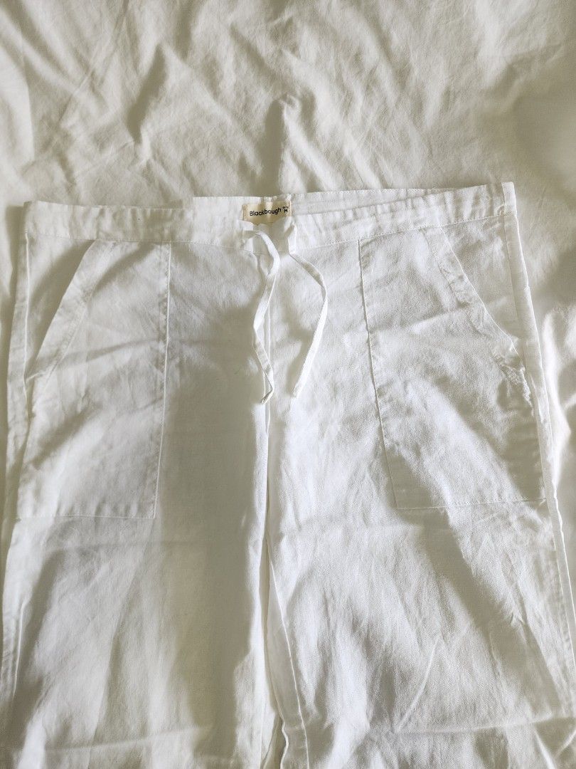 Blackbough White Linen Drawstring Pants (Beach Cover Up) (Category: Trousers) located in Taguig. Submitted by groovefunknsoul (Listing ID 1467048093, Image 2). Description: - Brand: Blackbough - Size: M (tagged on waistband) - Color: White - Material: Lightweight and breathable linen with natural texture - Fit: Straight-leg, great for warm weather - Features: Adjustable drawstring waist and convenient side pockets - Never used - For beach trips o